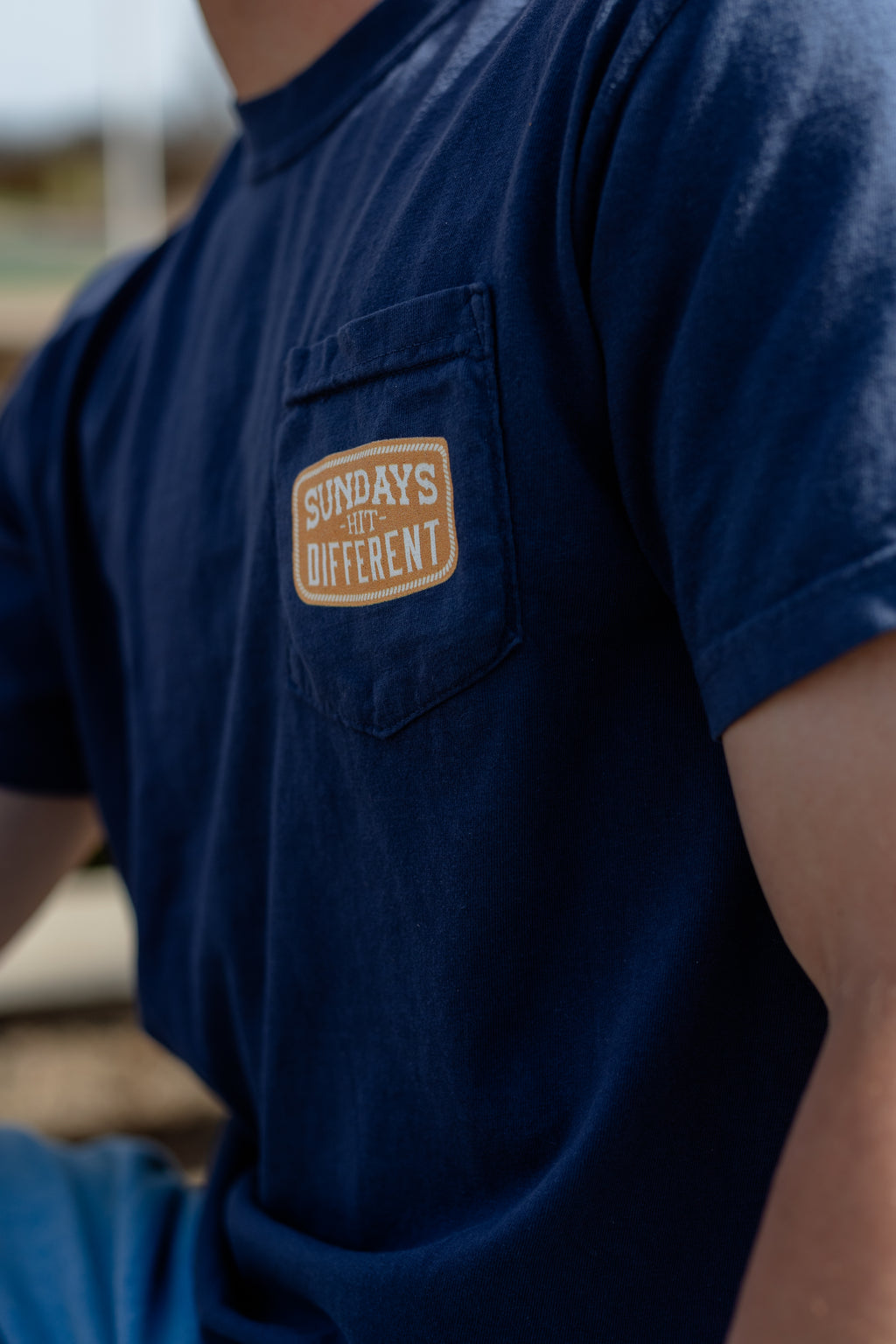 Sundays Hit Different Pocket Badge Tee