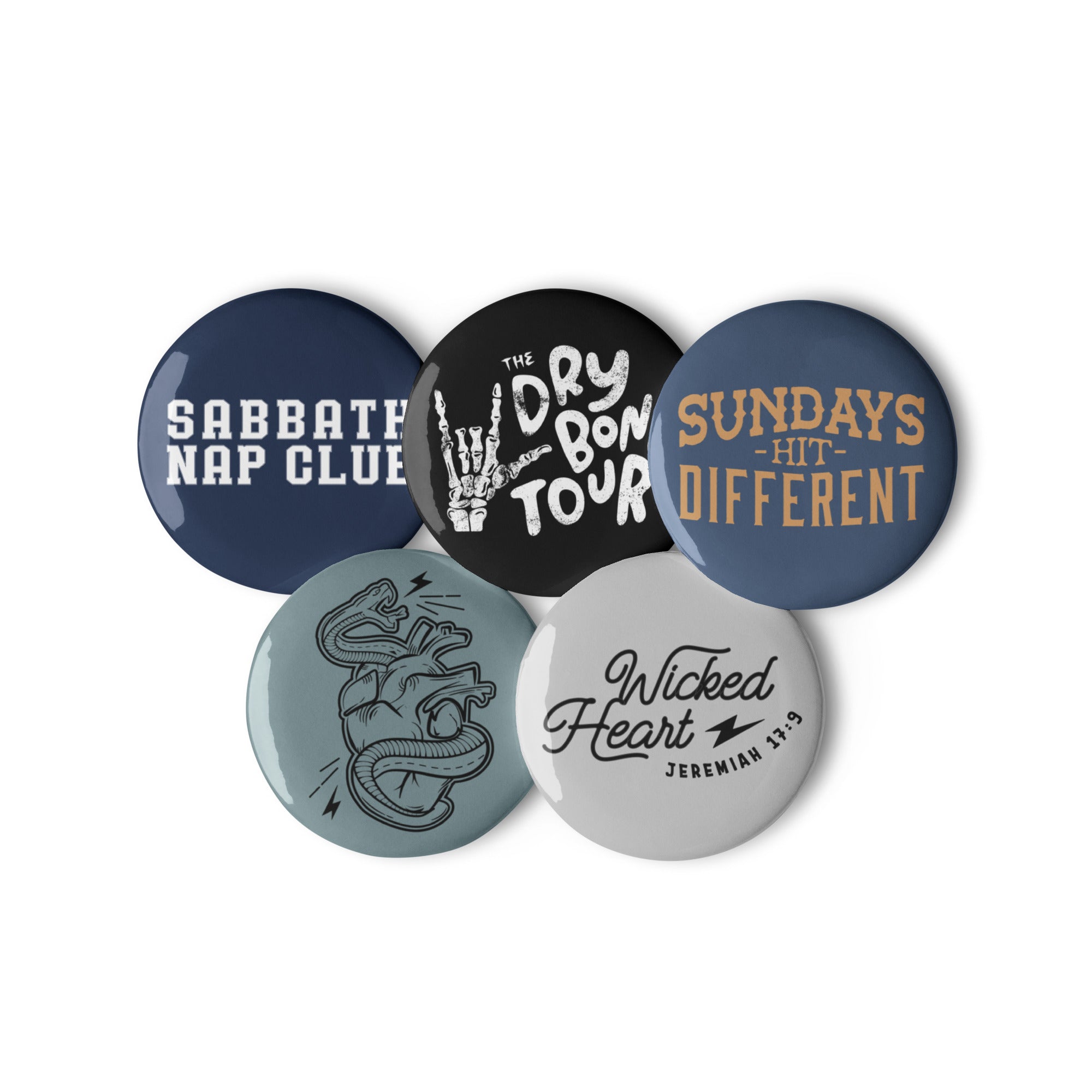 Set of 5 Religious Pin Buttons with graphics from faith based Christian company, Christian Shirts Shop shirt collections. Graphics included are Wicked Heart verse, Sundays Hit Different, Wicked Heart Serpent, The Dry Bones Tour, and Sabbath Nap Club.