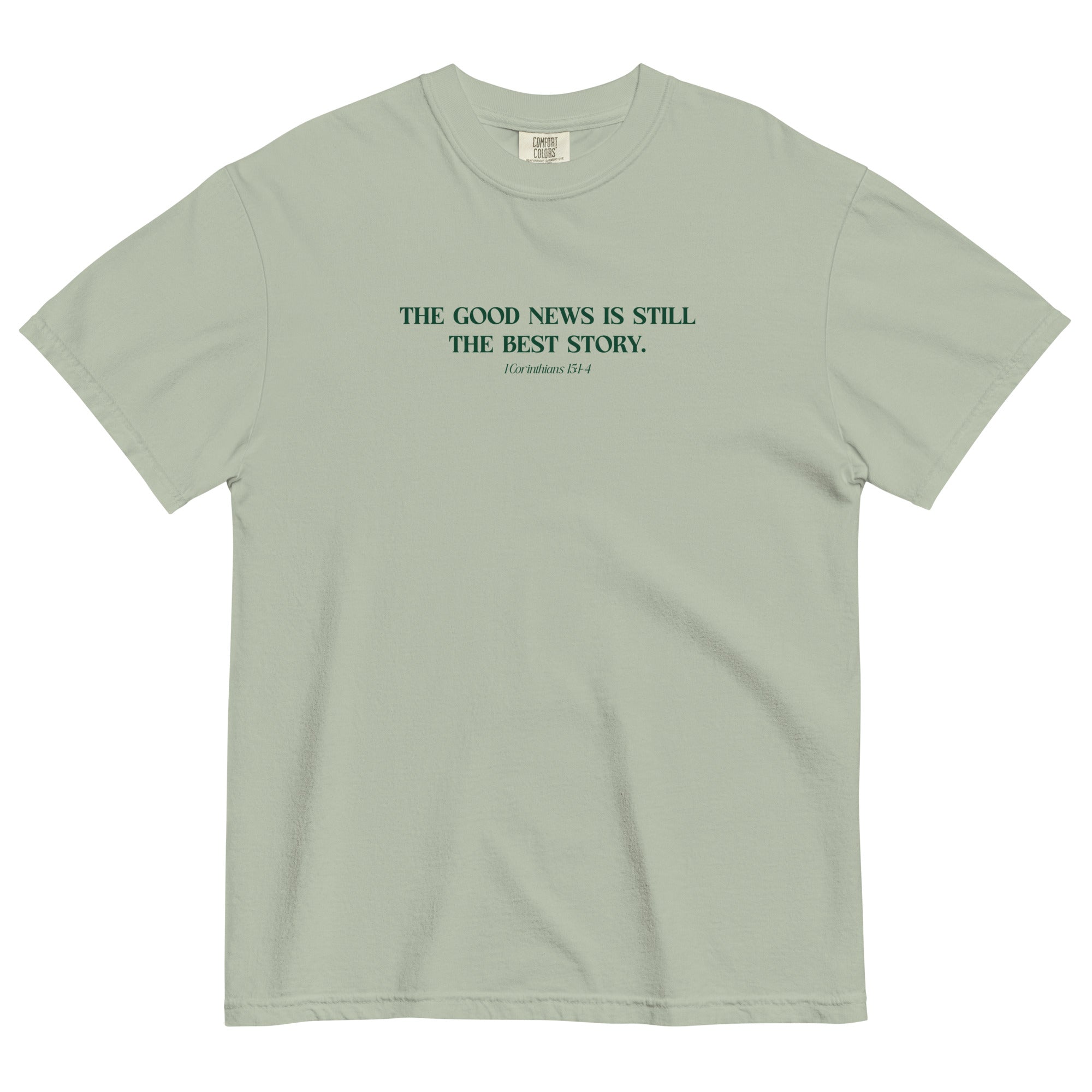 The Best Story Shirt from Faith based Christian company. Green Comfort Colors Shirt. Graphic: "The good news is still the best story. 1 Corinthians 15: 1-4"