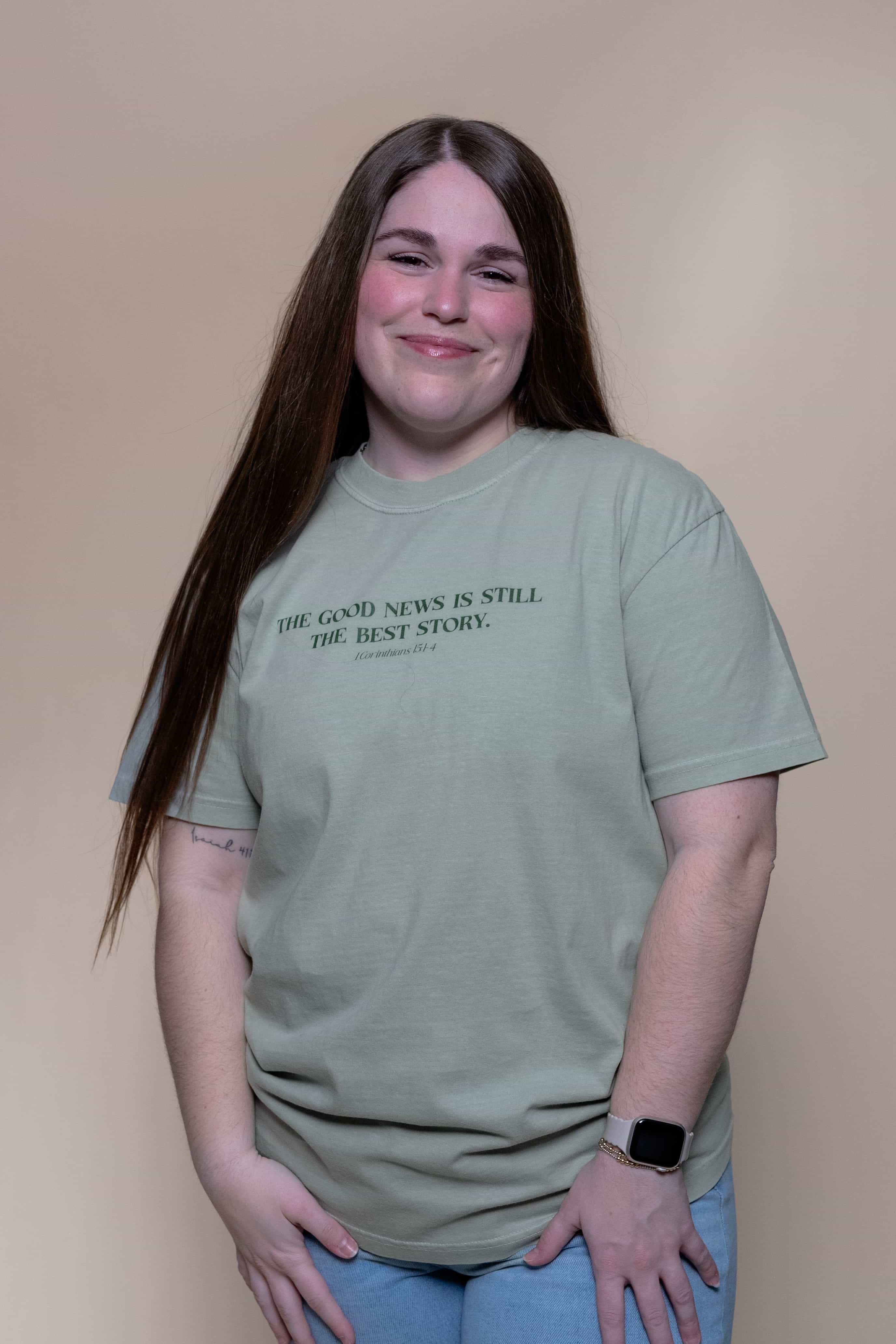 The Best Story Shirt from Faith based Christian company. Green Comfort Colors Shirt. Graphic: "The good news is still the best story. 1 Corinthians 15: 1-4"