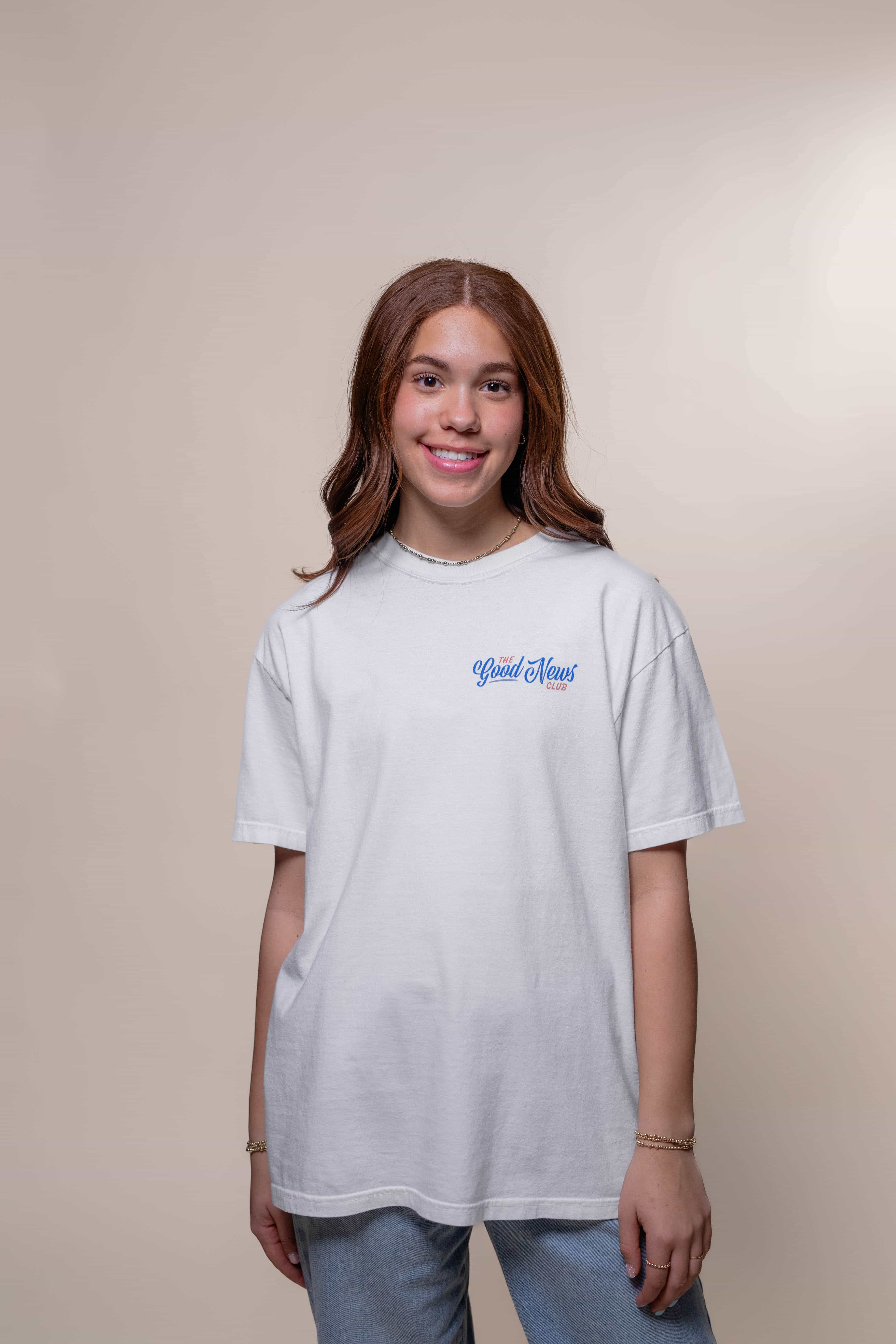 T-shirt from Faith based Christian company, Christian Shirts Shop. 
Graphic: The Good News Club John 3:16
Color: White shirt with red and blue graphics
Brand: Comfort Colors